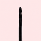Black eyelash curler on a pink background