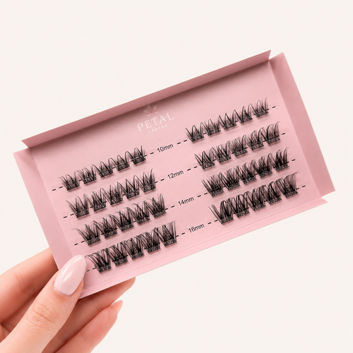 Set of false eyelashes in a pink packaging case held by a hand.