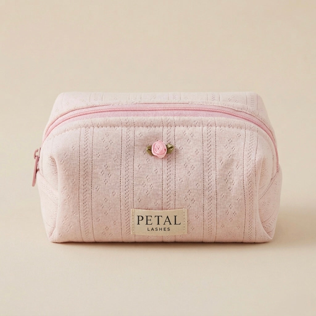 Pink makeup bag with a rose decal and 'Petal Lashes' label on a beige background