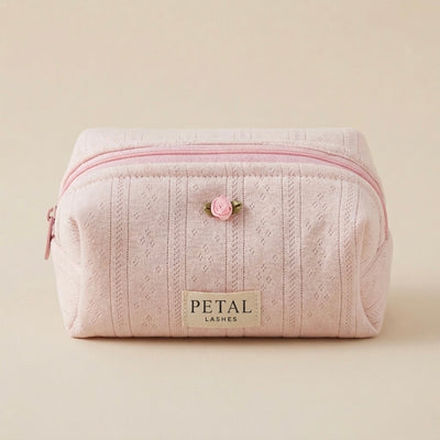 Pink makeup bag with a rose decal and 'Petal Lashes' label on a beige background