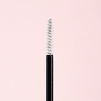 Black eyeliner pencil with silver cap on a light pink background