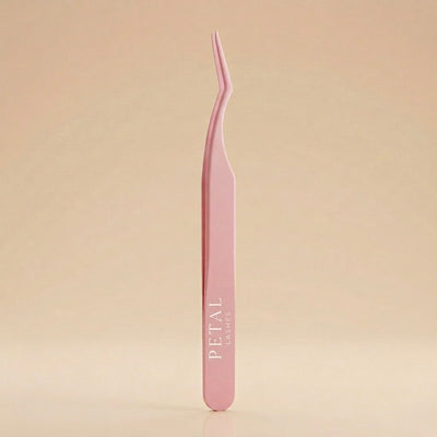 Pink tweezers with 'Petal' branding on a beige background
