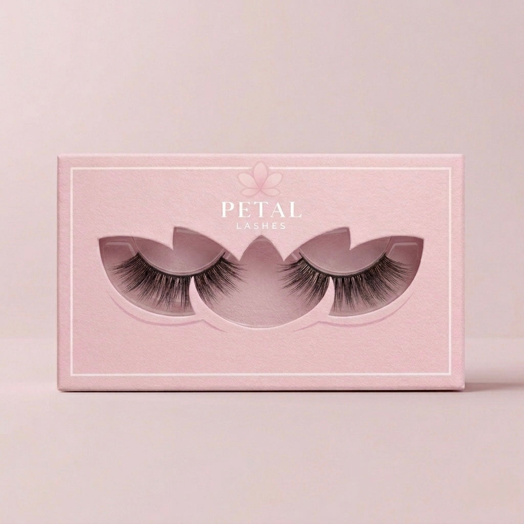 Pink box of false eyelashes with 'Petal Lashes' branding on a light pink background